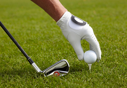 Pure Custom Gold glove and ball on tee on the Green