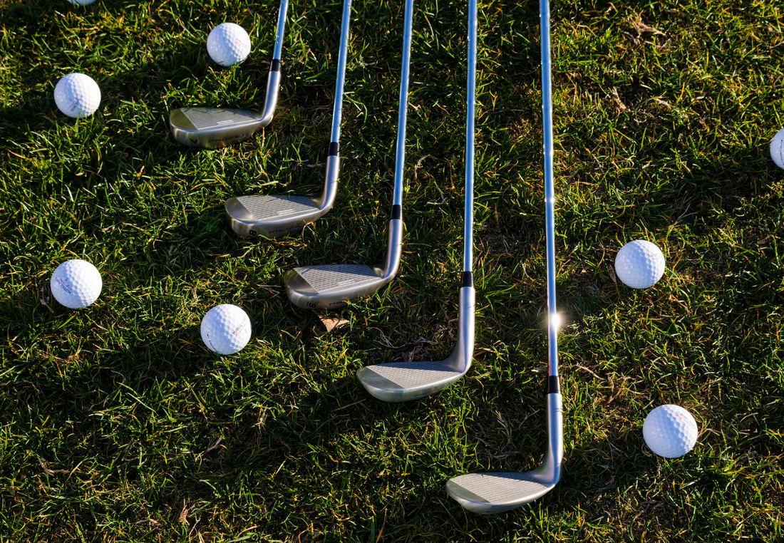 Golf Clubs and Golf Balls laid out on the green waiting for personalisation. 